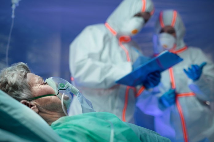 Infected patient in quarantine lying in bed in hospital, coronavirus concept.