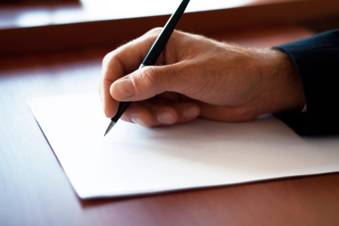 Man writing on the paper